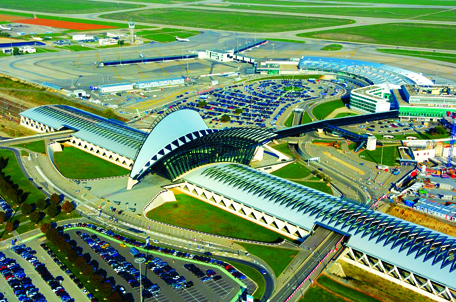 Tổng thể sân bay với khối sảnh cong kết nối trực tiếp với bãi đỗ ô tô và ga đường sắt ở 2 bên, Sân bay quốc tế Lyon-Saint Exupéry, Pháp