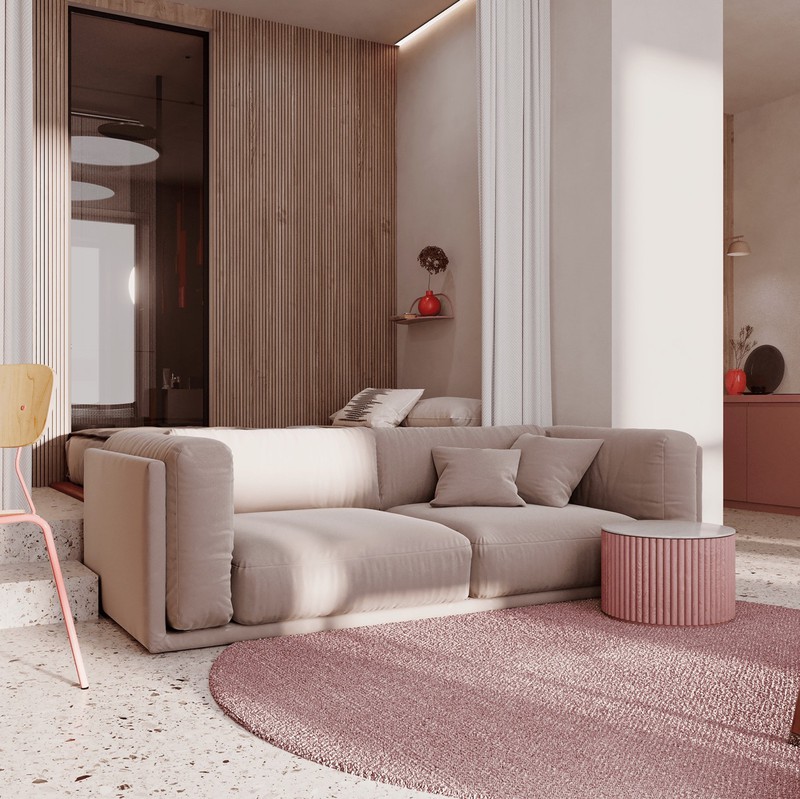 Ghế sofa thấp cho phép ánh sáng đi qua, làm nổi bật màu sắc tường phía sau căn hộ
