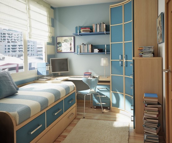 một căn phòng nhỏ đầy phong cách dành cho thanh thiếu niên màu xanh da trời và da rám nắng với giường có ngăn kéo để lưu trữ, bàn ở góc và tủ quần áo cong, kệ nổi và sách xếp chồng lên nhau