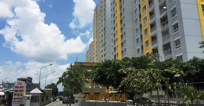 Chung cư Carina khoác chiếc áo mới với màu sơn đổi từ xanh dương sang vàng, tương đồng với màu sơn của chung cư City Gate Tower đối diện, cũng do NBB làm chủ đầu tư.