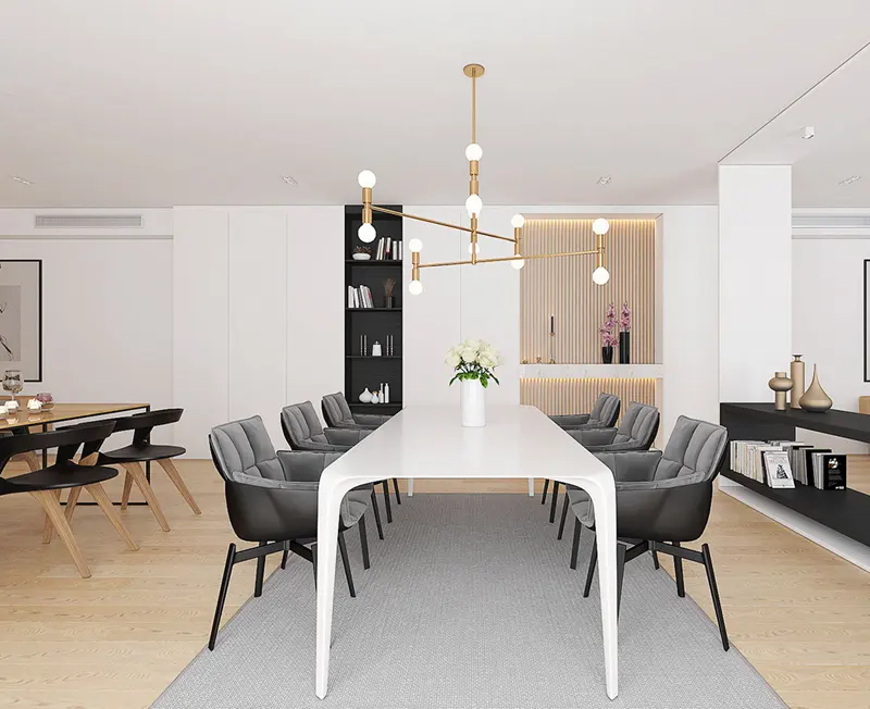 Ghế bọc nệm màu đen đặt cạnh bàn gỗ trắng, tạo sự tương phản ấn tượng. 