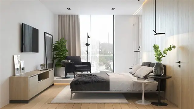 Bên kia giường, một chiếc ghế đọc sách thoải mái đặt sát với cửa sổ
