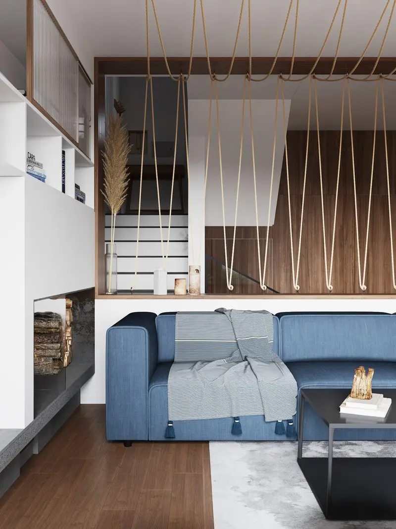 Trong phòng khách, một chiếc ghế sofa hiện đại màu xanh cộng với dây thừng kết theo dạng lưới, khiến ta liên tưởng đến cuộc sống của một ngư dân sống gần biển