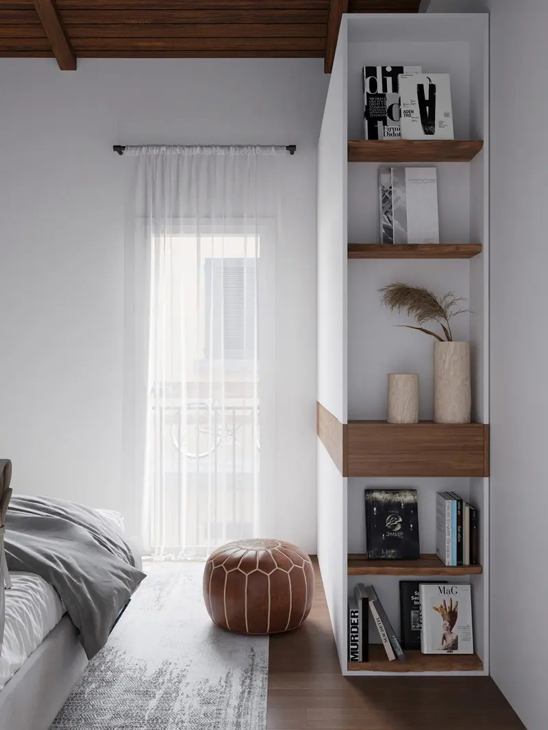 Một chiếc ghế đệm bọc da, đặt cạnh giá sách âm tường