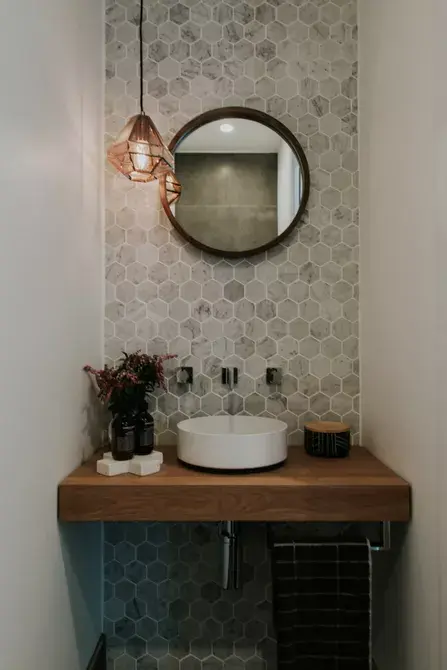 Gạch mosaic là loại gạch gồm nhiều viên gạch nhỏ với các màu sắc khác nhau được ghép trên một gạch lớn. Để bức tường gạch mosaic ở giữa hai bức tường sơn màu trắng giúp trung hòa màu sắc và khiến phòng tắm này không bị rối mắt.