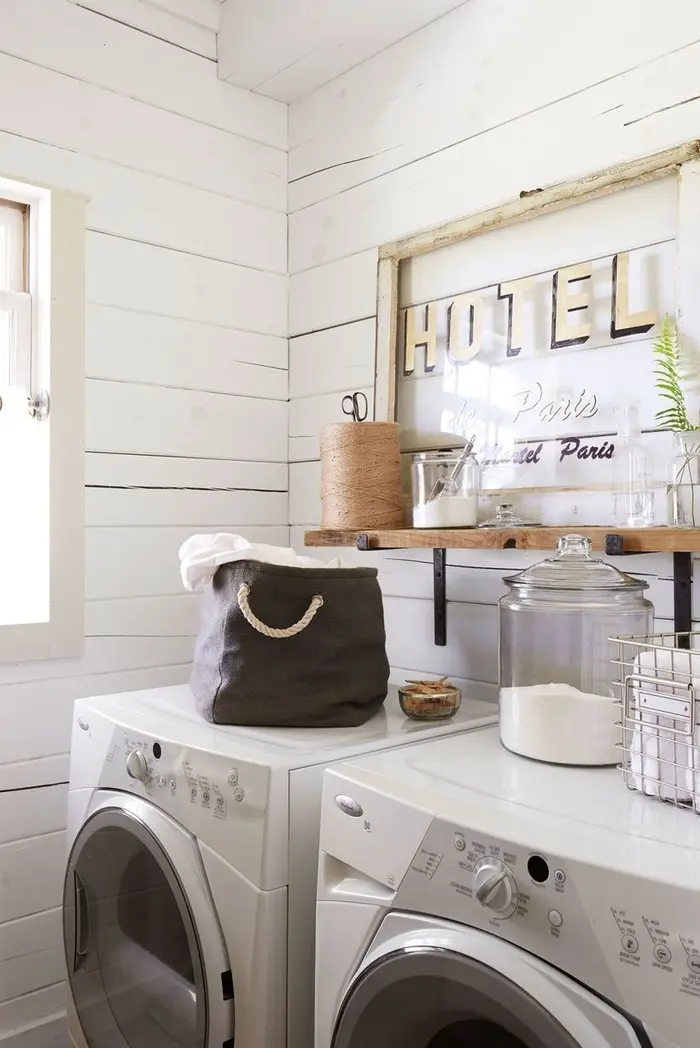 Hãy mang lại sức sống cho phòng giặt bằng cách trang trí những tác phẩm nghệ thuật treo tường cổ điển, lọ hoặc giỏ