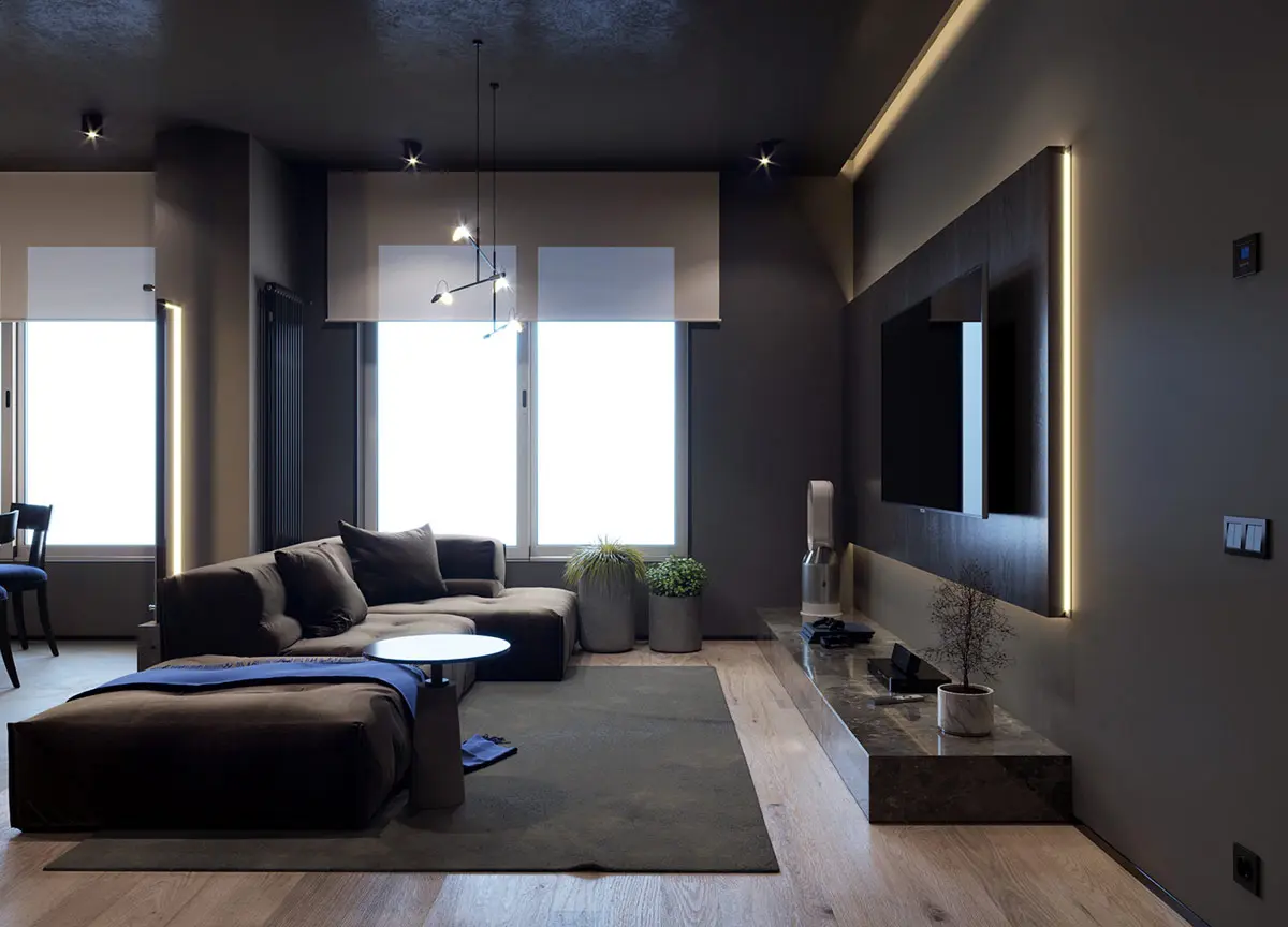 Cây trong nhà nép mình dưới cửa sổ, thu hút ánh nhìn xung quanh từ ghế sofa và lên bức tường TV được chiếu sáng