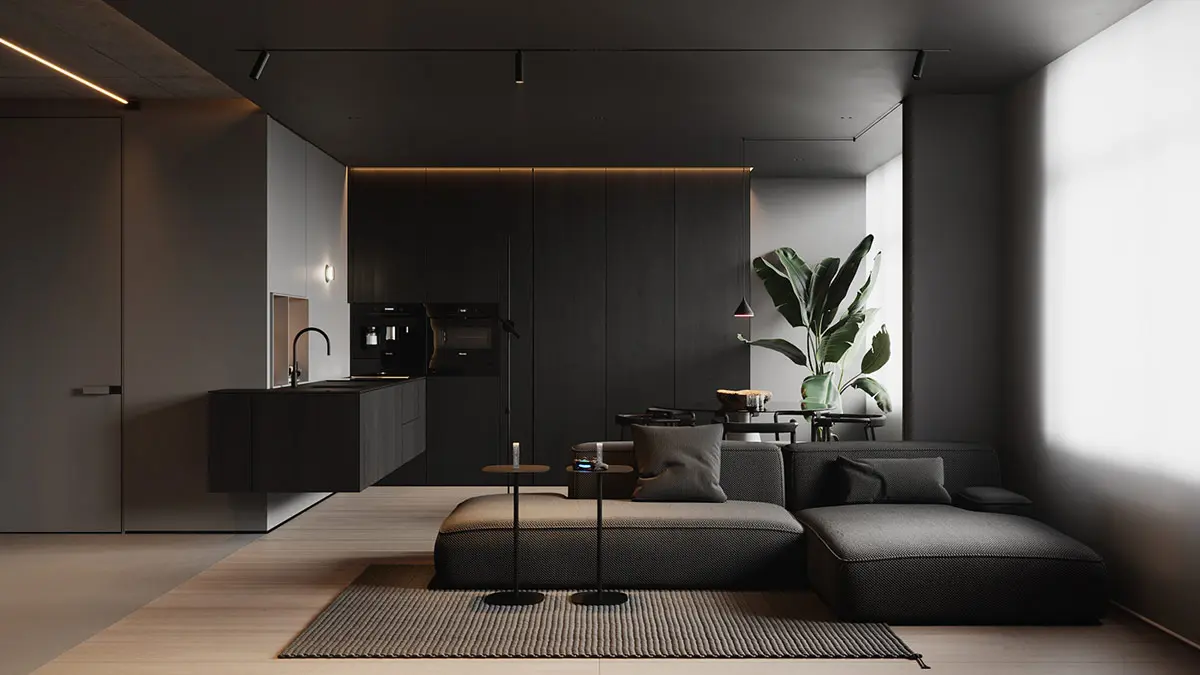 Một chiếc ghế sofa hiện đại có đường nét thấp trượt một hình bóng tuyến tính trên tấm thảm than hoa văn trong phòng khách, trong khi nhà bếp màu đen được nâng lên đường mái được chiếu sáng phía sau.